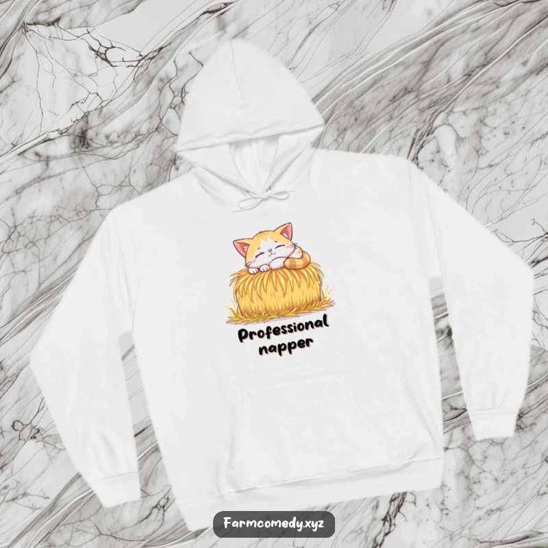 Funny Cat Sunbeam Nap Hoodie: A happy cat naps in a sunbeam on a hay bale, offering warmth and a funny vibe.